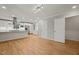 Open concept living room with a modern kitchen, hardwood floors, and natural light at 3420 Sheridan Dr, Durham, NC 27707