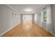 Spacious living room with beautiful hardwood floors, neutral walls, crown molding, and open access to additional rooms at 3420 Sheridan Dr, Durham, NC 27707
