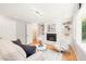 Living room with white brick fireplace, built-in shelving, and a comfortable sitting area at 3420 Sheridan Dr, Durham, NC 27707