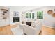 Inviting living room with a painted brick fireplace, built-in shelving, and bright natural light at 3420 Sheridan Dr, Durham, NC 27707