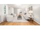 Light-filled living room featuring a patterned rug, hardwood floors, and white furniture at 3420 Sheridan Dr, Durham, NC 27707