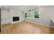 Bright living room with a fireplace, built-in shelving, and lots of natural light at 3420 Sheridan Dr, Durham, NC 27707
