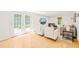 Living room with French doors leading to the backyard, neutral decor, and a big TV at 3420 Sheridan Dr, Durham, NC 27707