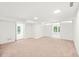 Bright, spacious living room with neutral carpet and access to the backyard at 3420 Sheridan Dr, Durham, NC 27707