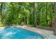 Relaxing poolside view with lounge chairs and a beautifully landscaped yard at 3420 Sheridan Dr, Durham, NC 27707