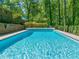 Inviting in-ground pool with clear blue water, surrounded by a well-maintained deck perfect for summer relaxation at 3420 Sheridan Dr, Durham, NC 27707