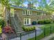 The back exterior of the brick home features a patio, stairs, fenced yard, and green lawn at 3420 Sheridan Dr, Durham, NC 27707