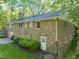 The expansive brick exterior featuring the yard, a fireplace chimney, multiple windows, and lawn at 3420 Sheridan Dr, Durham, NC 27707