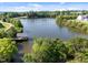 Beautiful aerial view of the lake and surrounding trees, with covered dock area at 353 Rivella Dr, Wake Forest, NC 27587