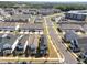 Aerial view of modern townhomes in a well-planned community showcasing the neighborhood's design under a clear blue sky at 353 Rivella Dr, Wake Forest, NC 27587
