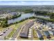 An aerial view of the lake near modern homes in a well-planned community and beautifully landscaped lawns at 353 Rivella Dr, Wake Forest, NC 27587