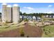 Aerial view of well-planned community featuring modern townhomes, a playground, and silos at 353 Rivella Dr, Wake Forest, NC 27587