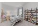 Bright bedroom features a bed with floral accents and a large bookshelf at 353 Rivella Dr, Wake Forest, NC 27587