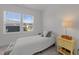 Bright bedroom with large window, lamp on bedside table, neutral walls, and simple decor at 353 Rivella Dr, Wake Forest, NC 27587