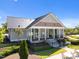 A community clubhouse featuring a covered entrance, well-manicured landscaping, and plenty of natural light at 353 Rivella Dr, Wake Forest, NC 27587