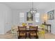 Bright dining room featuring a rustic table, unique chairs, and modern lighting fixture at 353 Rivella Dr, Wake Forest, NC 27587