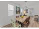 Bright dining room featuring a rustic table, unique chairs, and modern lighting fixture at 353 Rivella Dr, Wake Forest, NC 27587