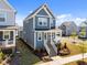 Stylish two-story home boasting blue siding, a cozy front porch, and lush landscaping, perfect for suburban living at 353 Rivella Dr, Wake Forest, NC 27587