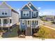 Charming two-story home with blue siding, a welcoming front porch, and a well-manicured lawn in a Gathering-friendly neighborhood at 353 Rivella Dr, Wake Forest, NC 27587