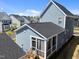 Exterior view of a blue home with a screened-in porch and dark gray roof in residential neighborhood at 353 Rivella Dr, Wake Forest, NC 27587