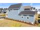 Two-story blue home with well-manicured lawn and landscaping, side yard at 353 Rivella Dr, Wake Forest, NC 27587