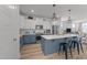 Open-concept kitchen with modern appliances, sleek countertops, and two-tone cabinets, seamlessly connecting to the living space at 353 Rivella Dr, Wake Forest, NC 27587