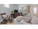 Cozy living room with stylish furniture, a large TV, and patterned curtains, creating a comfortable and inviting atmosphere at 353 Rivella Dr, Wake Forest, NC 27587