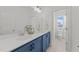 Bathroom with a double sink vanity, white countertops and blue cabinetry with an open view to the toilet at 353 Rivella Dr, Wake Forest, NC 27587
