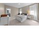 Calm main bedroom with a queen bed, chair and ottoman, dresser and soft natural light at 353 Rivella Dr, Wake Forest, NC 27587