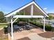 Covered outdoor picnic area with tables, surrounded by greenery, ideal for community gatherings at 353 Rivella Dr, Wake Forest, NC 27587