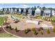 A community playground featuring a slide and modern play structures, with colorful new homes and manicured lawns at 353 Rivella Dr, Wake Forest, NC 27587