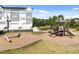 Community playground featuring modern play structures, soft landing surfaces, and nearby townhomes at 353 Rivella Dr, Wake Forest, NC 27587