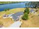 Beautiful lakefront home featuring a swimming pool, detached garage, and manicured lawn at 3636-A Holly Grove Rd, Dunn, NC 28334