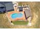 Aerial view of a backyard oasis with a pool, putting green, and enclosed area at 3636-A Holly Grove Rd, Dunn, NC 28334