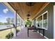 Covered porch with outdoor furniture, ceiling fans, and views of the lake at 3636-A Holly Grove Rd, Dunn, NC 28334
