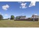 Expansive backyard includes a spacious lawn, stone retaining wall and distant views at 3636-A Holly Grove Rd, Dunn, NC 28334