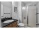 A well-lit bathroom features a vanity with black countertop and glass-enclosed shower at 3636-A Holly Grove Rd, Dunn, NC 28334