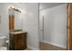 Bathroom vanity with granite countertops and wood-look flooring at 3636-A Holly Grove Rd, Dunn, NC 28334