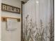 Neutral-toned bathroom featuring a freestanding tub and floral curtain at 3636-A Holly Grove Rd, Dunn, NC 28334