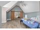 Large bedroom featuring vaulted ceilings, wooden beams, barn doors, and wood floors at 3636-A Holly Grove Rd, Dunn, NC 28334
