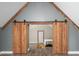 Unique bedroom with vaulted ceilings, wooden beams, and a barn door entrance, creating a cozy and inviting atmosphere at 3636-A Holly Grove Rd, Dunn, NC 28334