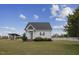 Charming cottage with white picket fence and picturesque landscaping, offering a cozy and inviting curb appeal at 3636-A Holly Grove Rd, Dunn, NC 28334