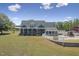 Beautiful home with a sunroom, backyard pool, and well-maintained lawn on a sunny day at 3636-A Holly Grove Rd, Dunn, NC 28334