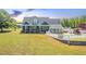 Expansive home with sunroom, pool, and putting green, nestled on a sprawling lawn at 3636-A Holly Grove Rd, Dunn, NC 28334