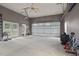 Spacious garage with a white door, work area, and convenient access to the backyard through French doors at 3636-A Holly Grove Rd, Dunn, NC 28334