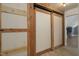 Hallway with hardwood floors and rustic closet with sliding doors for easy access at 3636-A Holly Grove Rd, Dunn, NC 28334