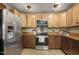 Cozy kitchen featuring stainless appliances, and a combination of stained and light cabinets at 3636-A Holly Grove Rd, Dunn, NC 28334