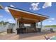 Expansive outdoor kitchen and bar area perfect for entertaining with seating and lake views at 3636-A Holly Grove Rd, Dunn, NC 28334