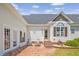 Charming patio with outdoor seating, brick flooring, and manicured landscaping at 3636-A Holly Grove Rd, Dunn, NC 28334