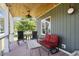 Comfortable covered porch with outdoor seating and lake views at 3636-A Holly Grove Rd, Dunn, NC 28334